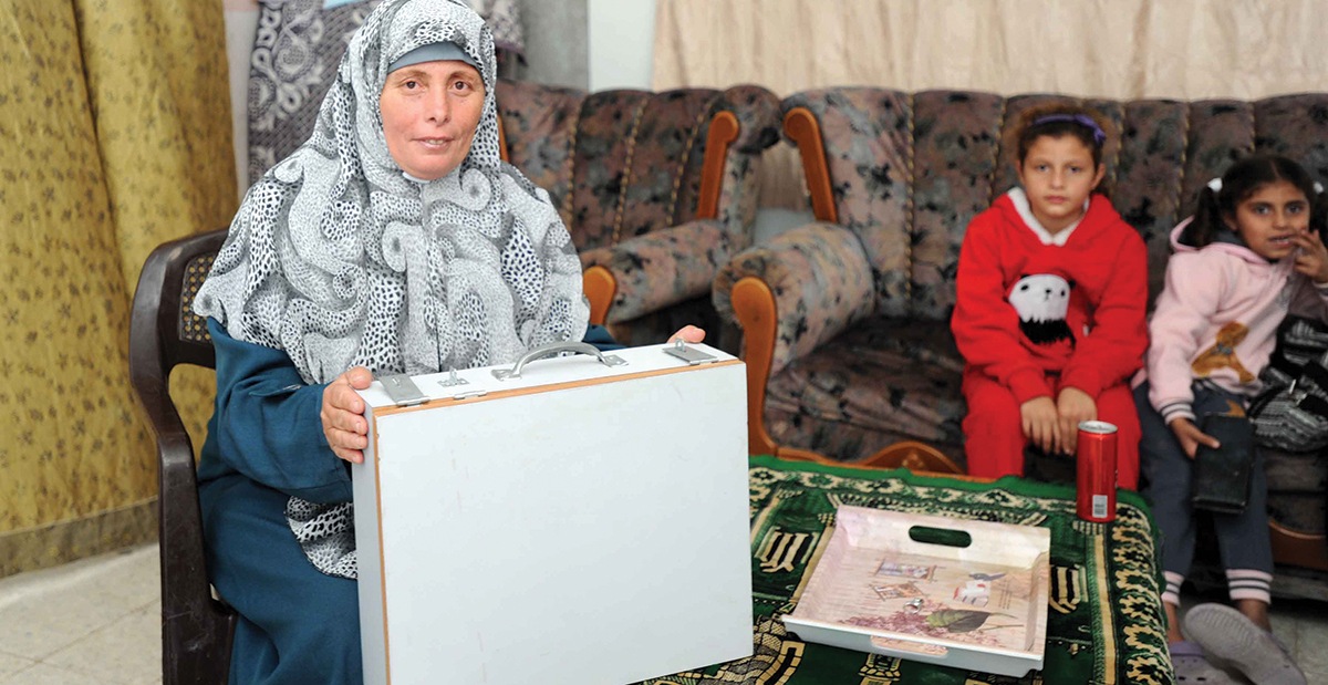Sena’a, a bookkeeper for a SILC group in Gaza, protected this trunk of cash during fighting. Photo by Shareef Sarhan for CRS