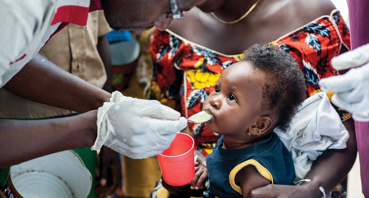 A child receives medication to prevent malaria through a CRS project in Mali. Photo by Michael Stulman/CRS