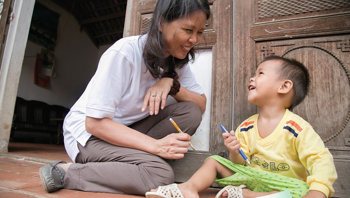Ngoc is unable to walk, talk or control her muscle movements. As a result of CRS’ collaboration with local government to provide home-based educational opportunities, she now lives a healthier life. Photo by Jennifer Hardy/CRS
